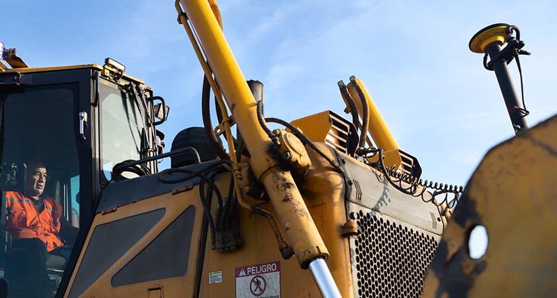 Construction worker on a yellow dozer with Leica iCON machine control system installed